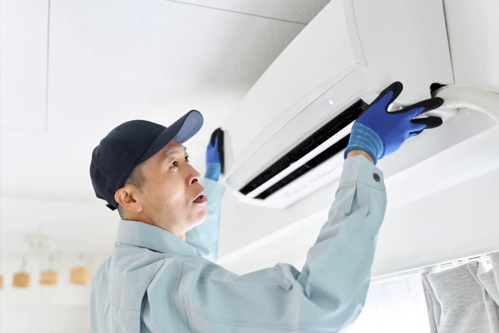 asian-worker-inspecting-air-conditioner-2023-12-30-01-16-07-utc (1)